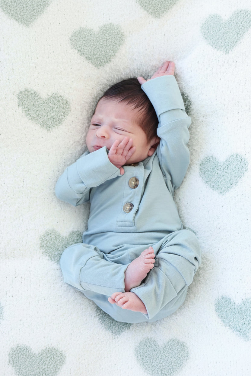 Baby wearing a 2pc Bamboo Button Top & Bottom in the color Ocean. 