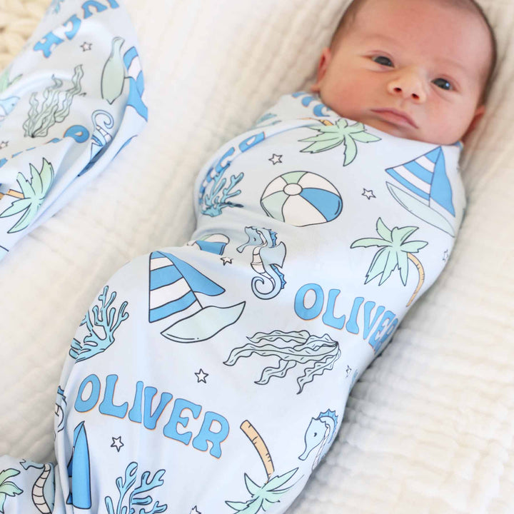 sailboat, palm tree, beach ball personalized swaddle blanket blue 