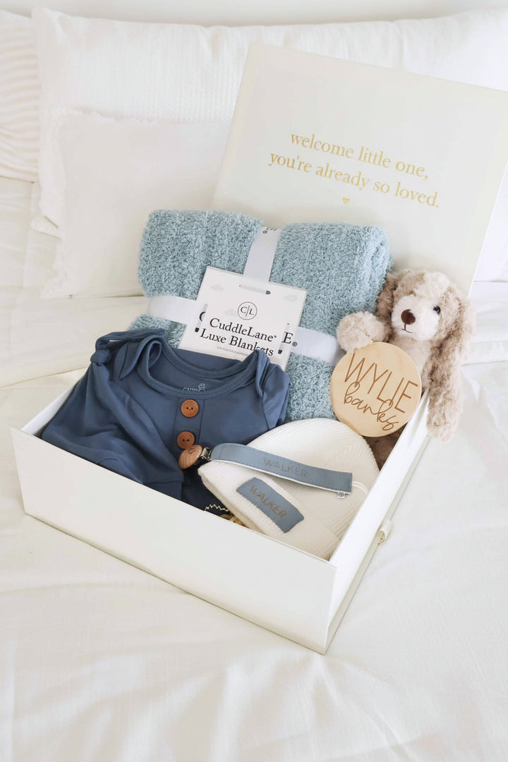 baby shower gift box bundle with blue pajamas, blanket and stuffed toy animal for boy