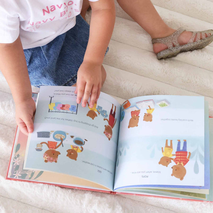 girl reading personalized kids books from grandparents