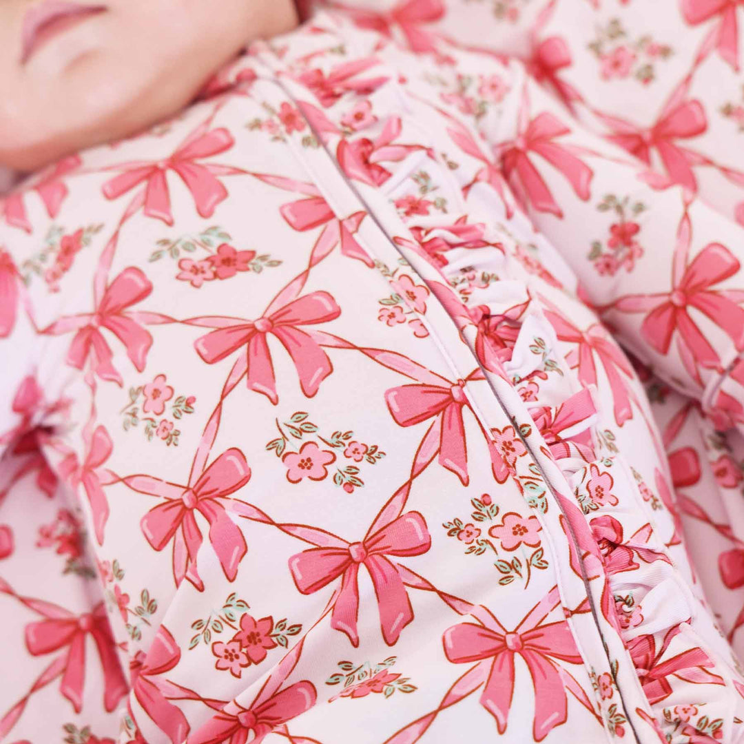 mom and baby matching pajamas with pink bows and flowers