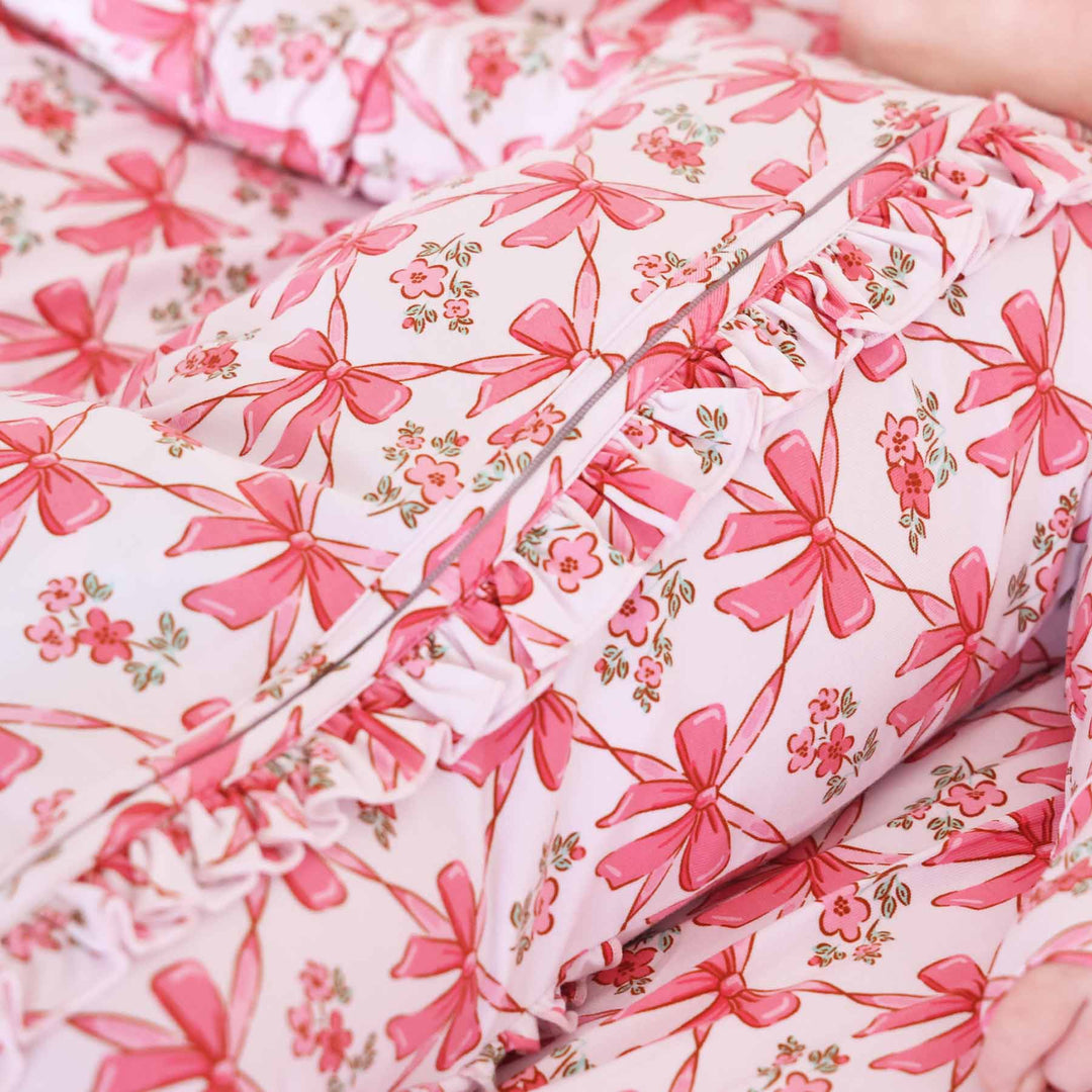 pink bow ruffle zipper footie for babies made from bamboo 