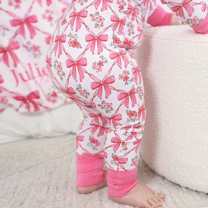 full zip romper with pink details and bow print for babies