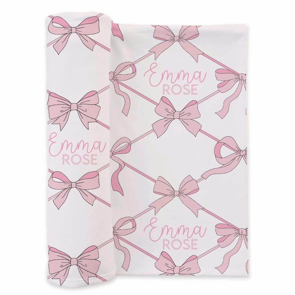 printed newborn baby swaddle with pink bows and personalized name for girls