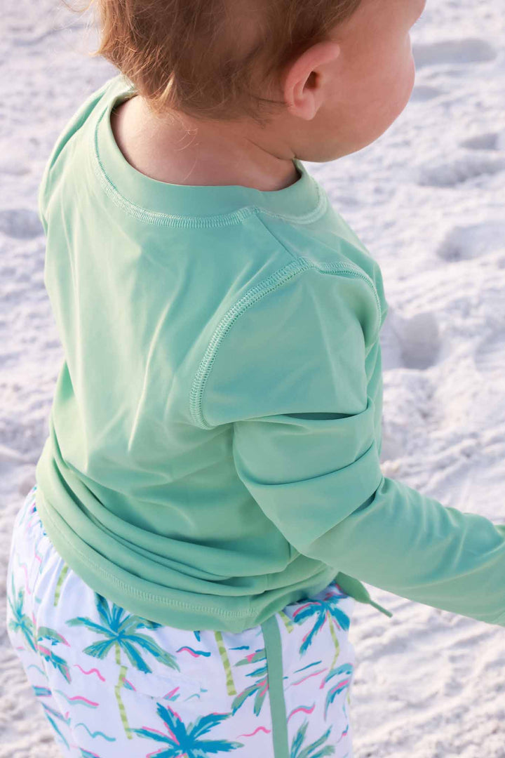 closeup of tropical green rash guard shirt for boys 