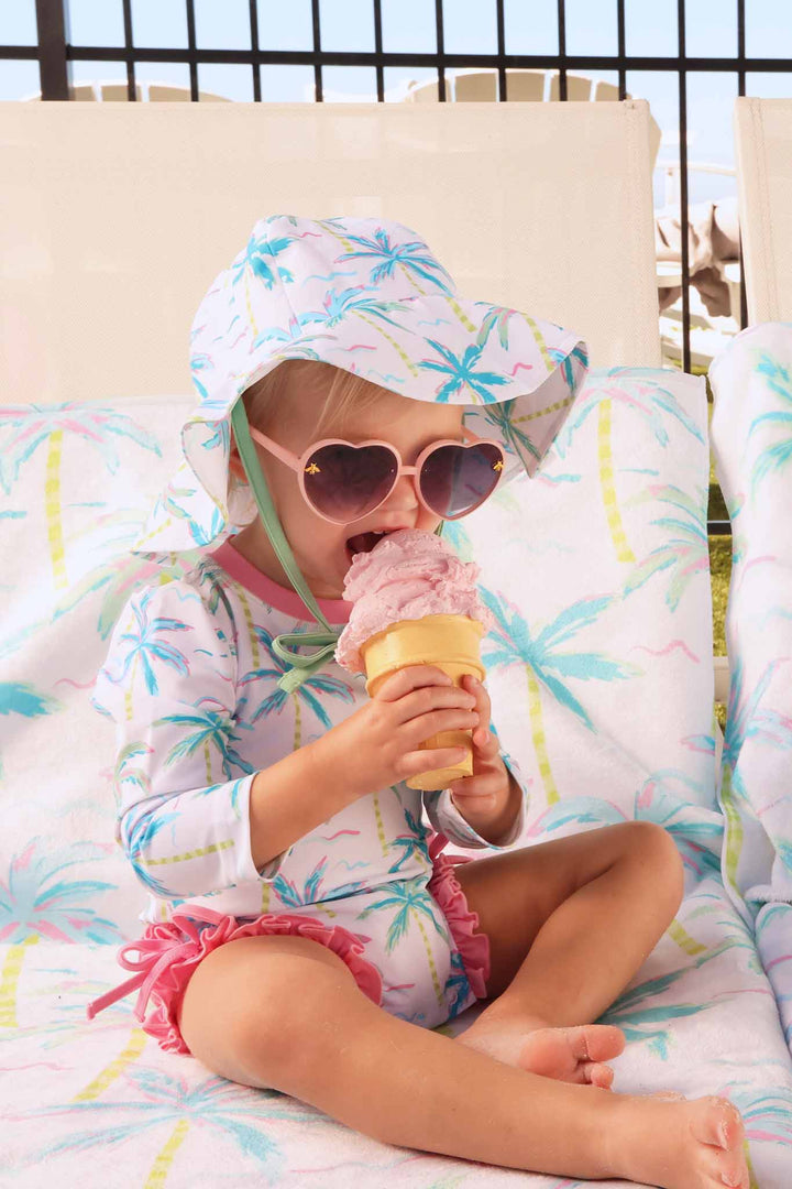blue lagoon long sleeve rash guard with ruffle bottom with a matching hat in upf 50+ fabric 