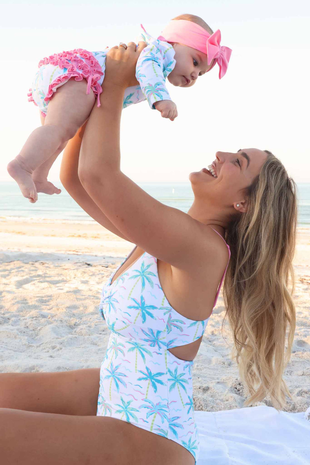 blue lagoon women's cutout swimsuit with matching rash guard swimsuit and pink swim bow