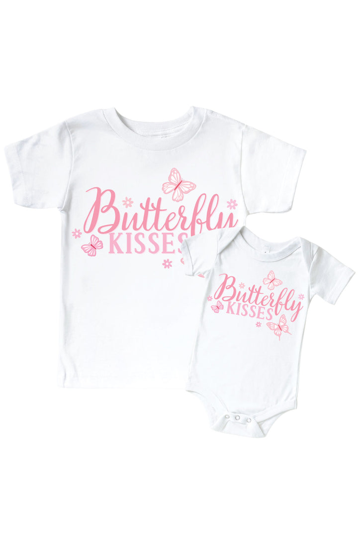 Butterfly Kisses Graphic Bodysuit & Kids Tee in Blooming Butterflies print - white tee and baby bodysuit displayed together, both with pink "Butterfly Kisses" script and butterfly graphics