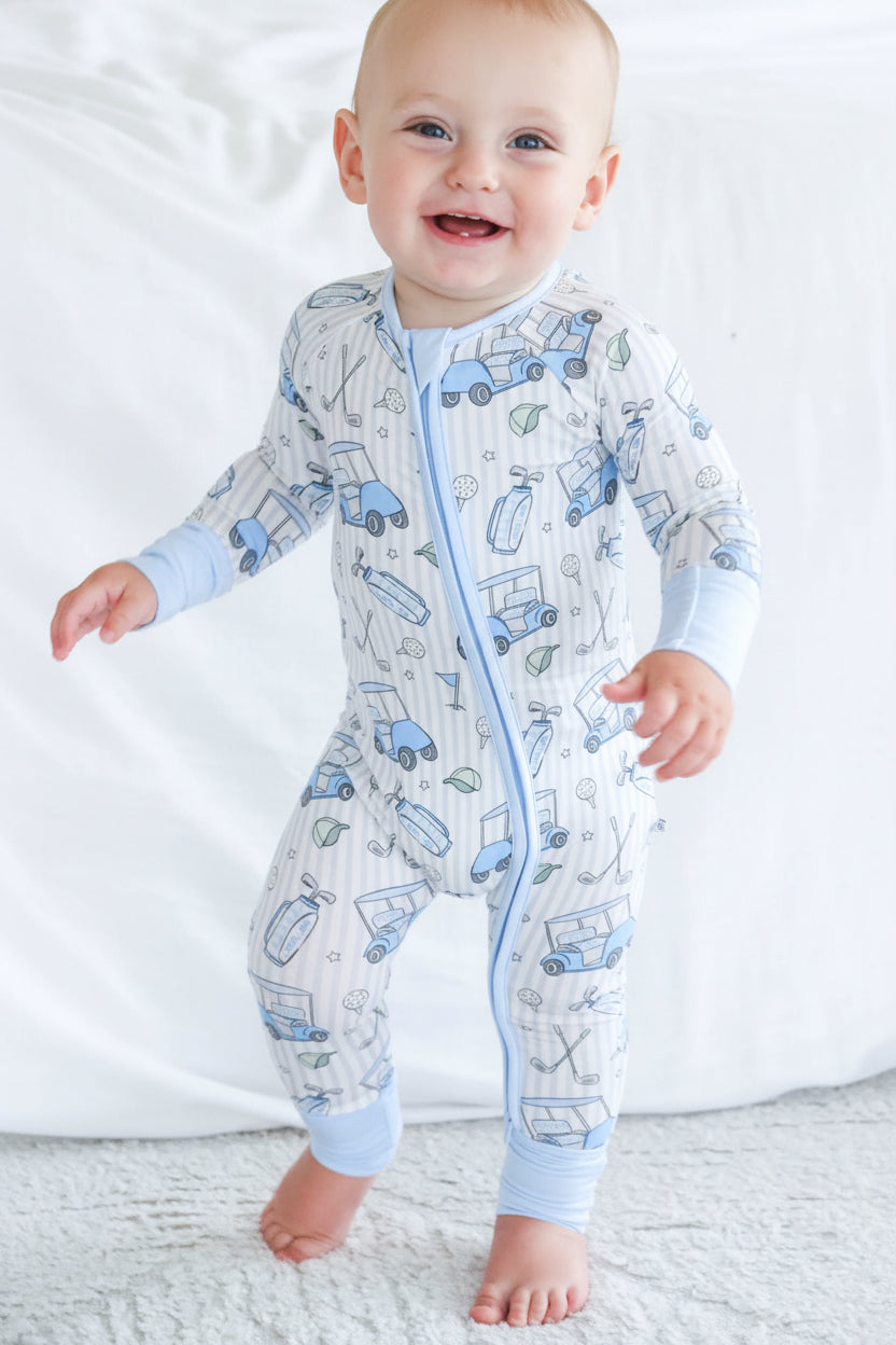baby in golf pajama romper