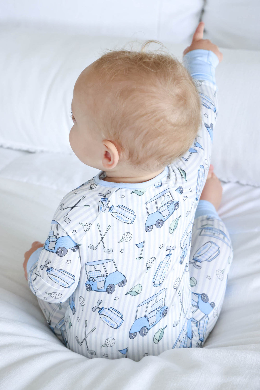 back view of caddie crew blue zip romper