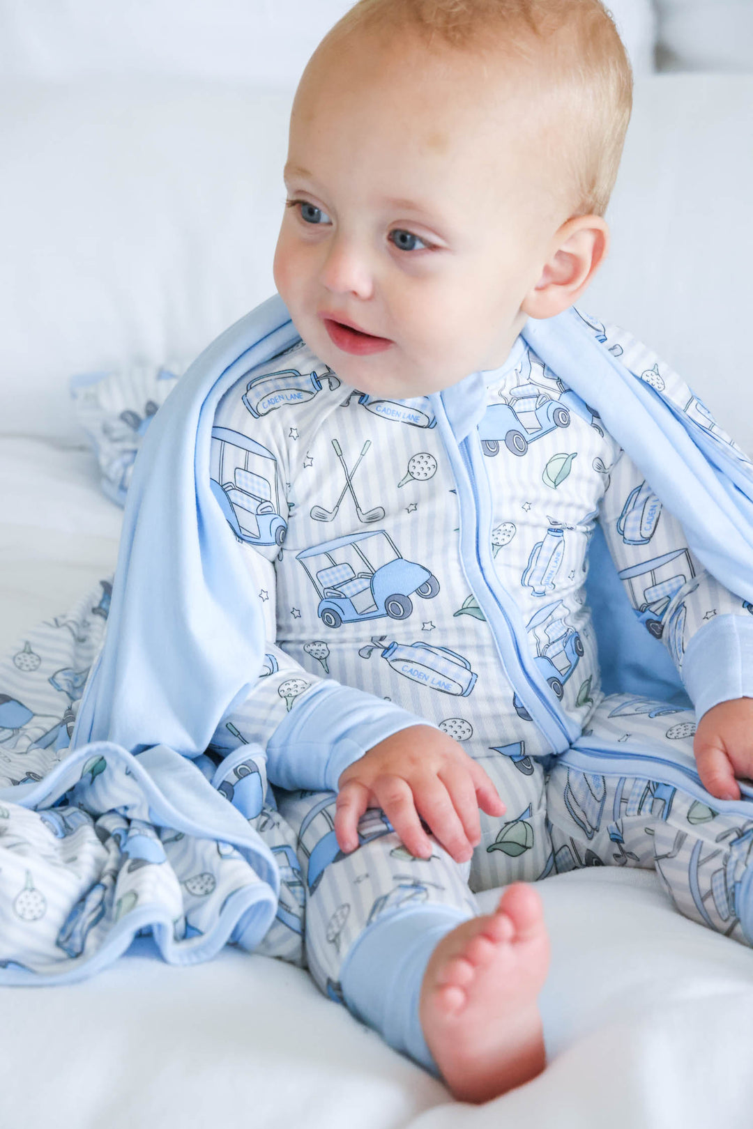 blue preppy golf zip romper pajama with matching bamboo blanket