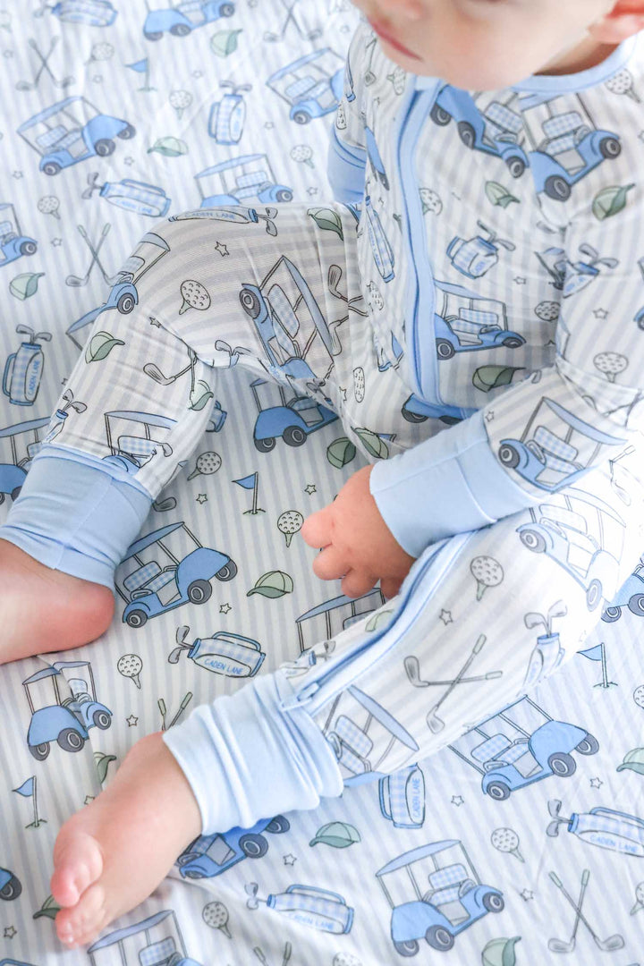 top view of caddie crew blue pajama romper with double sided bamboo blanket