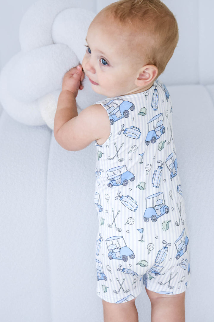 toddler boy standing up in caddie crew blue sleeveless snap romper