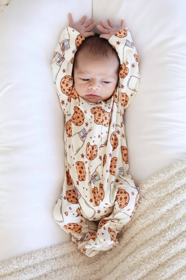 baby laying in lounger with a milk and cookies zipper footie pajama