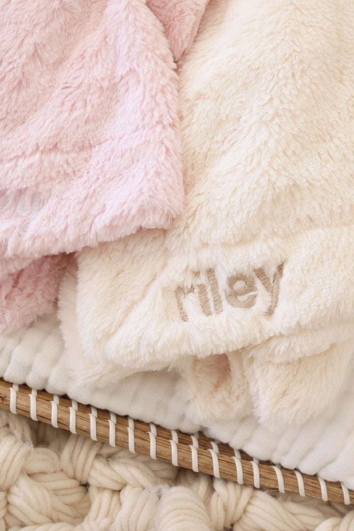 closeup of plush bunny lovies in pink and white that can be embroidered with the baby's name 