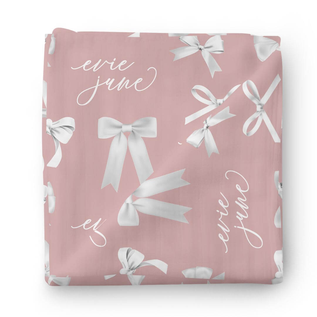 dark mauve personalized swaddle with white bows 
