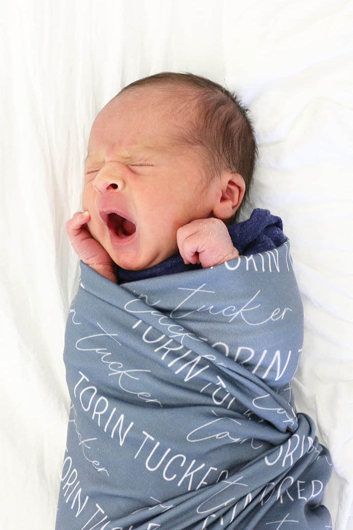 personalized dusty blue baby name swaddle blanket block and script 