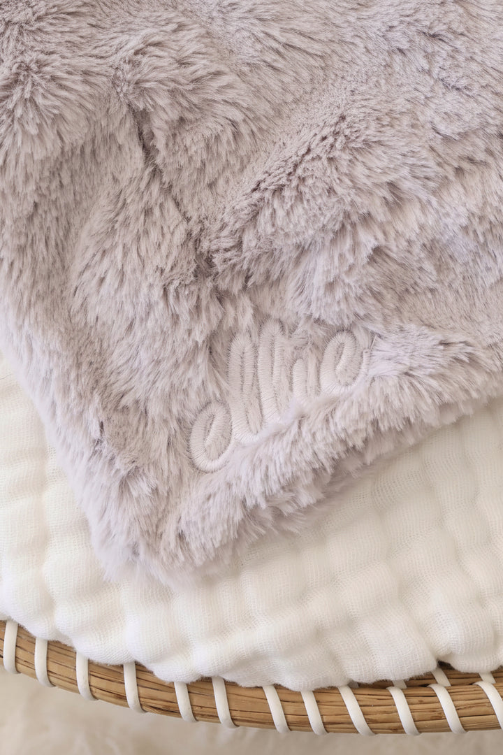 closeup of grey elephant lovey with white thread script font name 