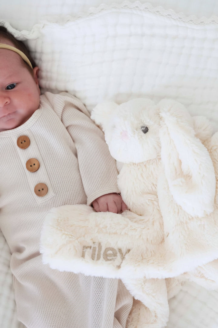 white stuffed animal bunny lovey for babies embroidered with name in beige thread and block font 
