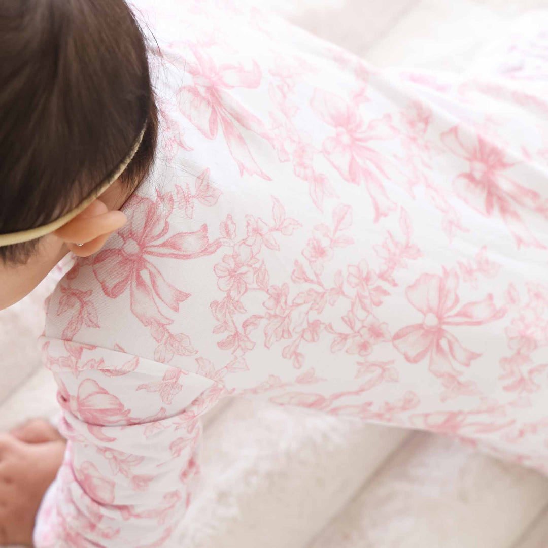 pink and white bow print bamboo ruffle zipper footie for baby girls 