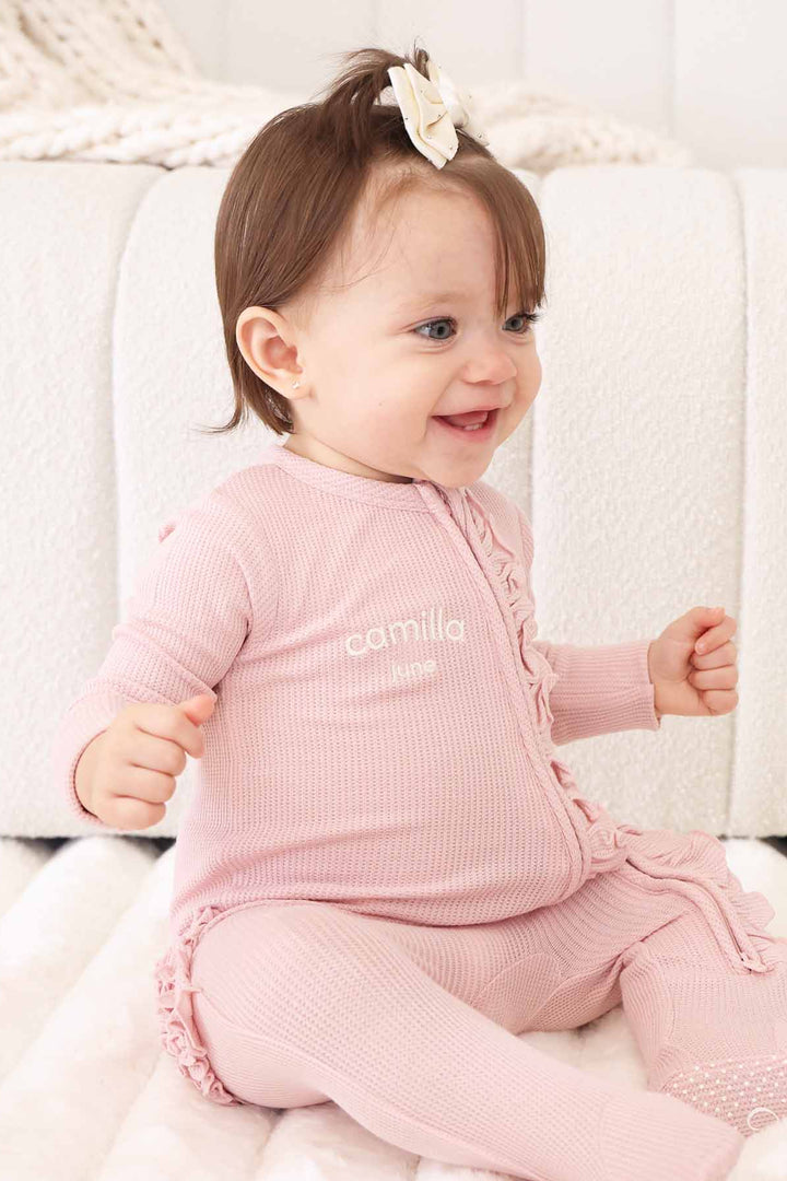 light pink bamboo waffle zipper ruffle footie embroidered with name 