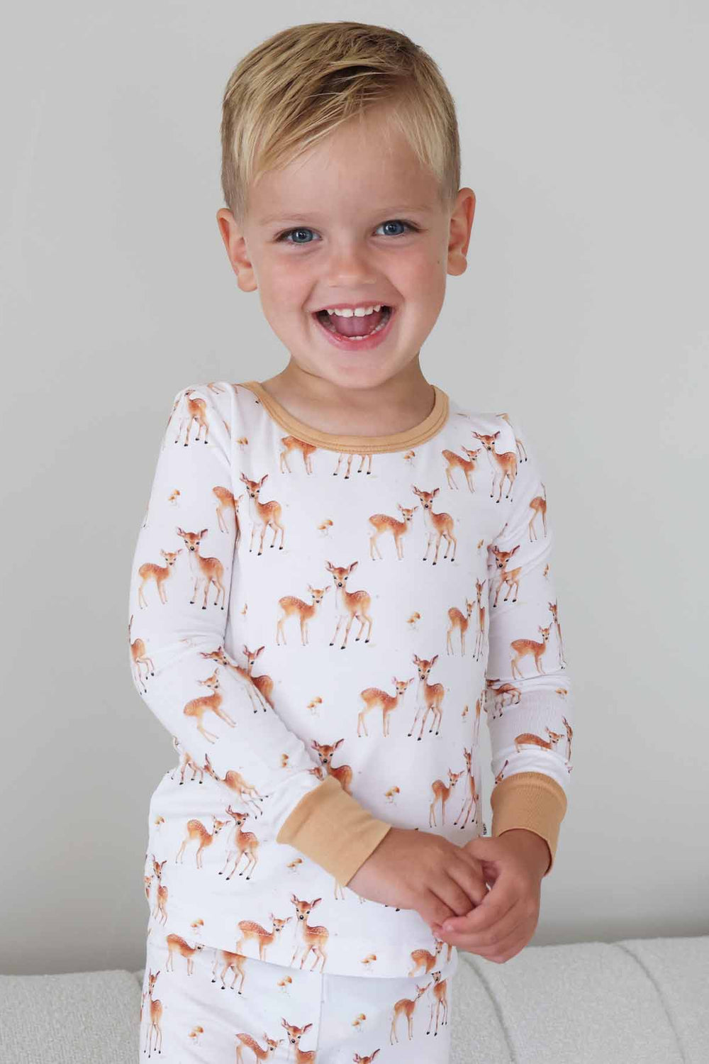 Happy boy in woodland fawn print pajamas 