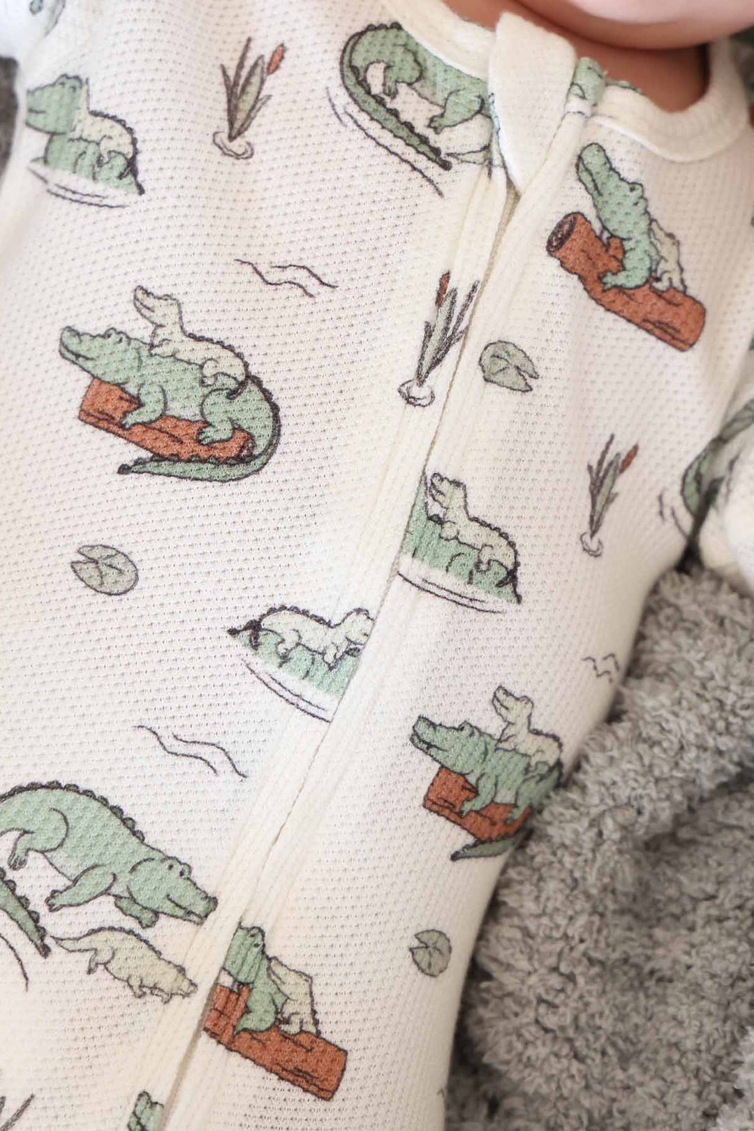 bamboo waffle zipper footie for baby boys with alligators floating on a log and lily pads
