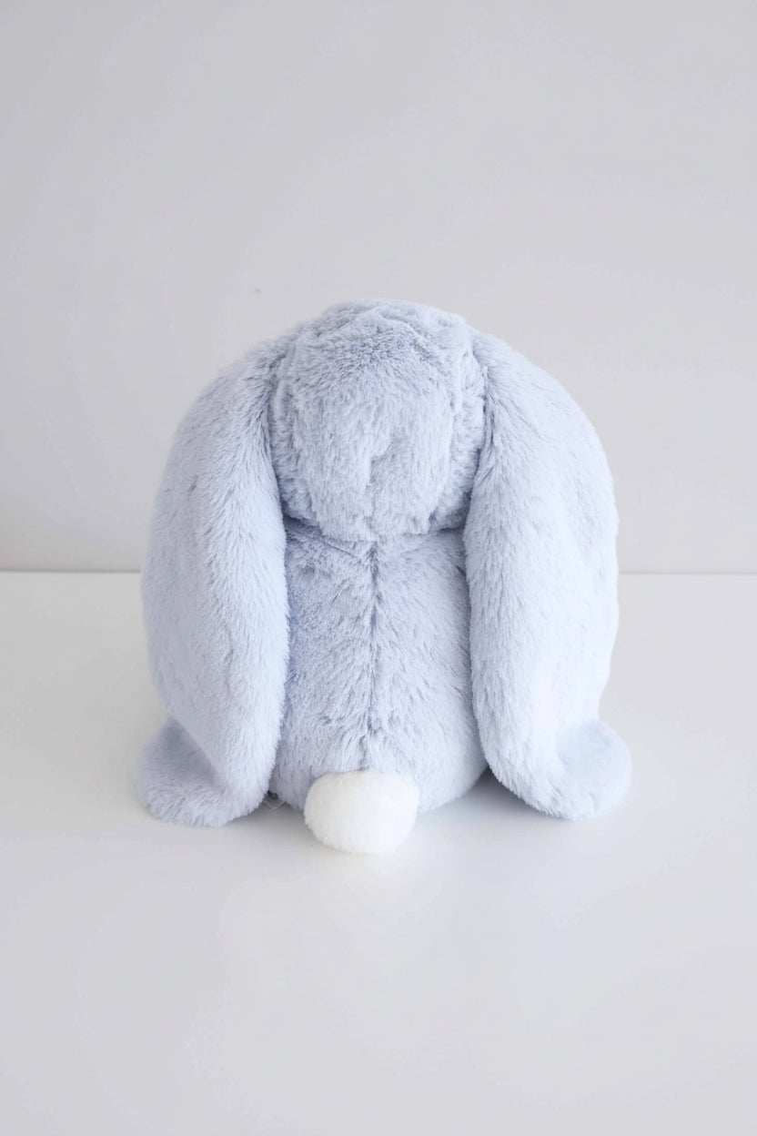 back view of light blue stuffed animal bunny with white fluffy tail
