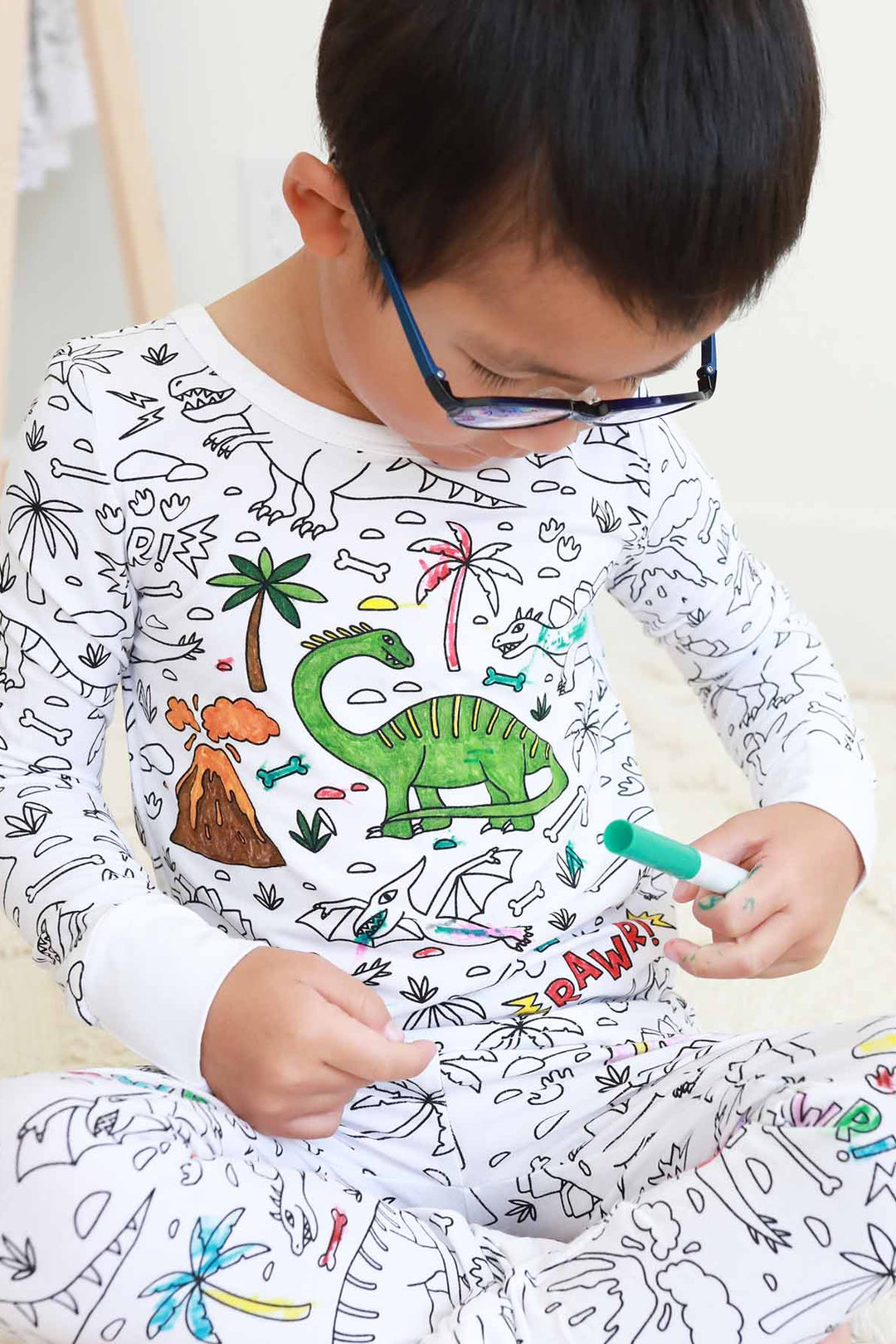 boy wearing Jurassic Playground Colorable Pajama Two Piece Set
