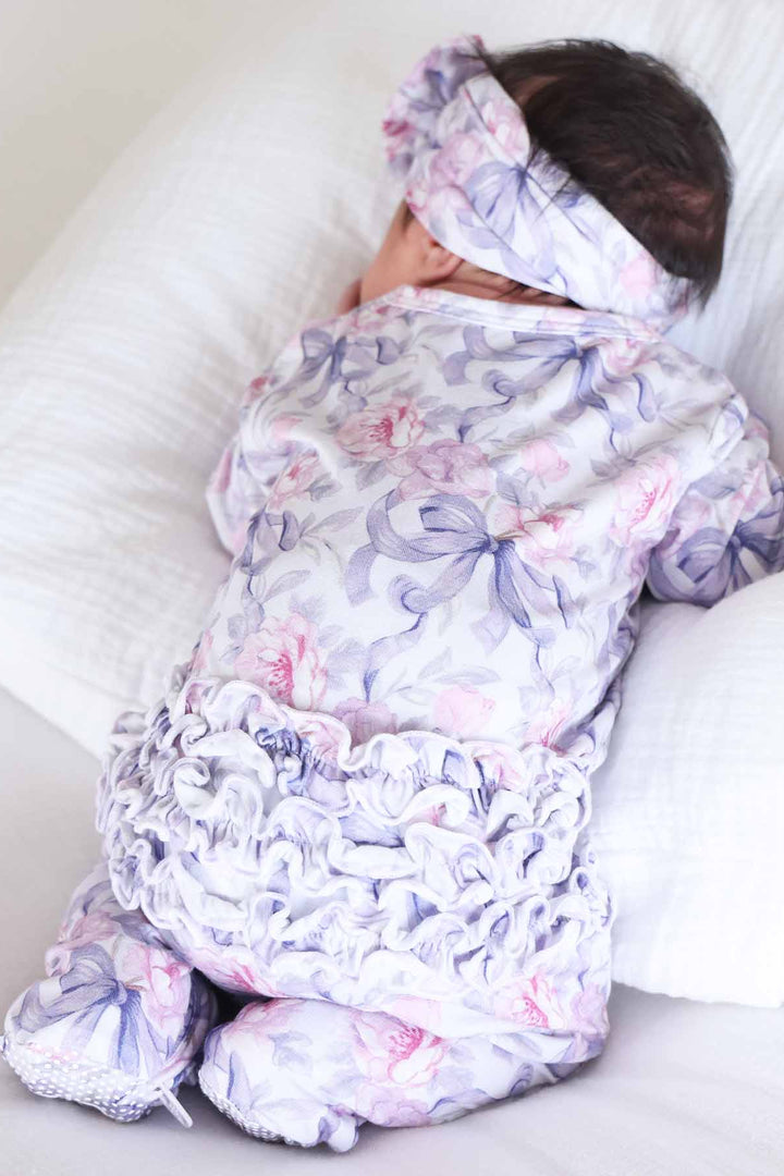 leighton's lavender ruffle bottom zipper footie for girls pink and purple rose and ribbon bows
