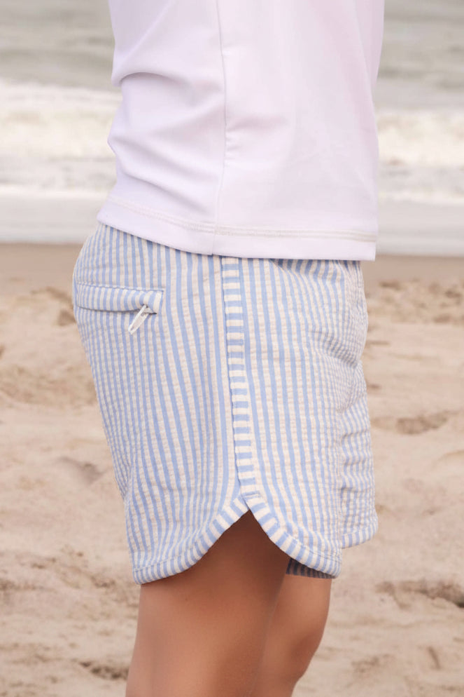 lightweight and breathable boy's swim trunks in seersucker blue with zip pocket detail