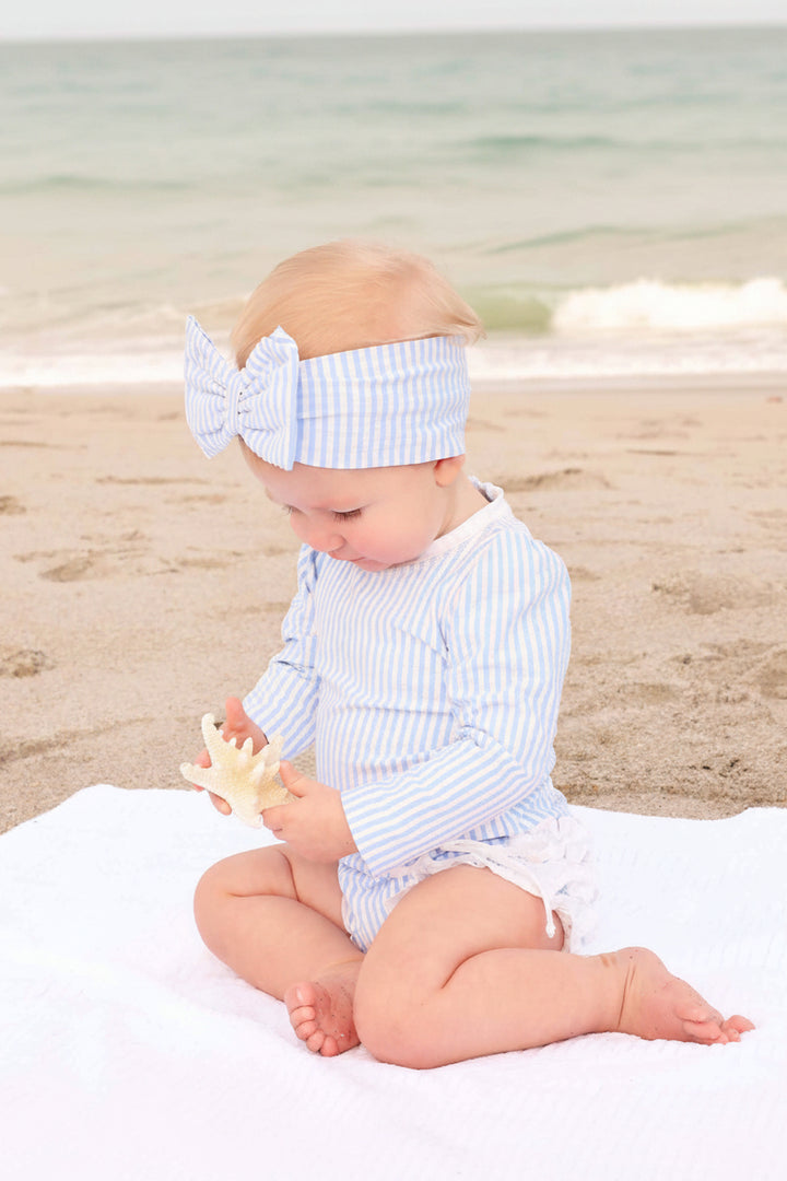 classic blue seersucker rash guard with ruffle swim bottoms and matching matching headwrap