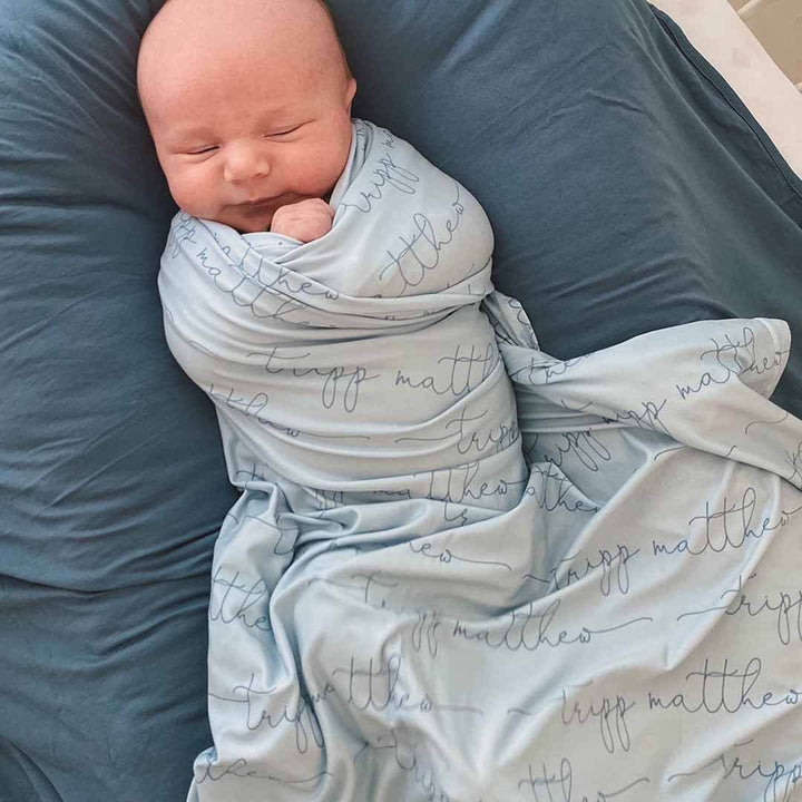 light dusty blue personalized baby name swaddle blanket all script 