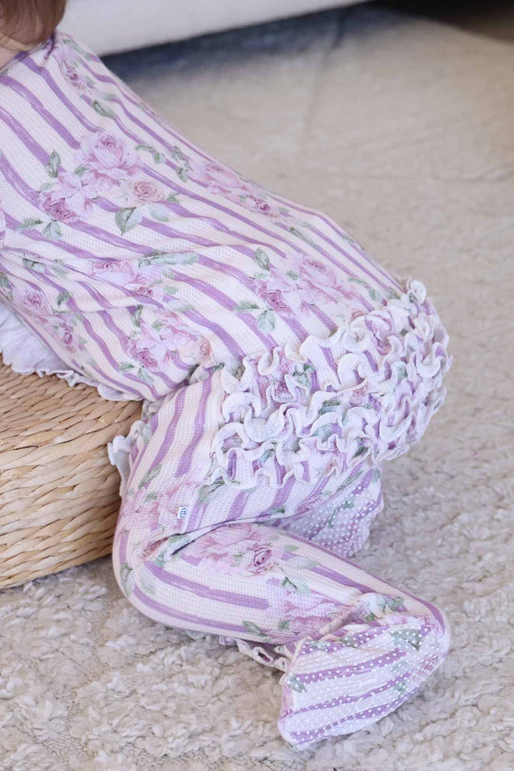 crawling baby in lila's lilacs zipper footie with ruffles on the bottom 