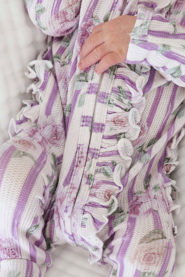 bamboo waffle zipper footie for newborn girls wit vintage purple stripes and roses with ruffles along the zipper and bottom 