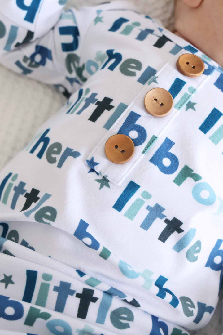 newborn wearing little brother knot gown