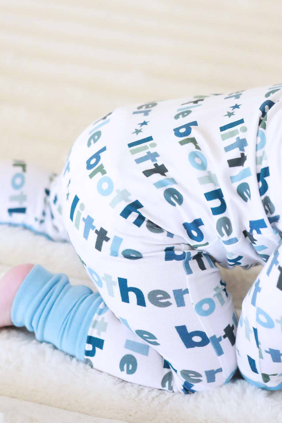 boy wearing little brother zip romper detailed