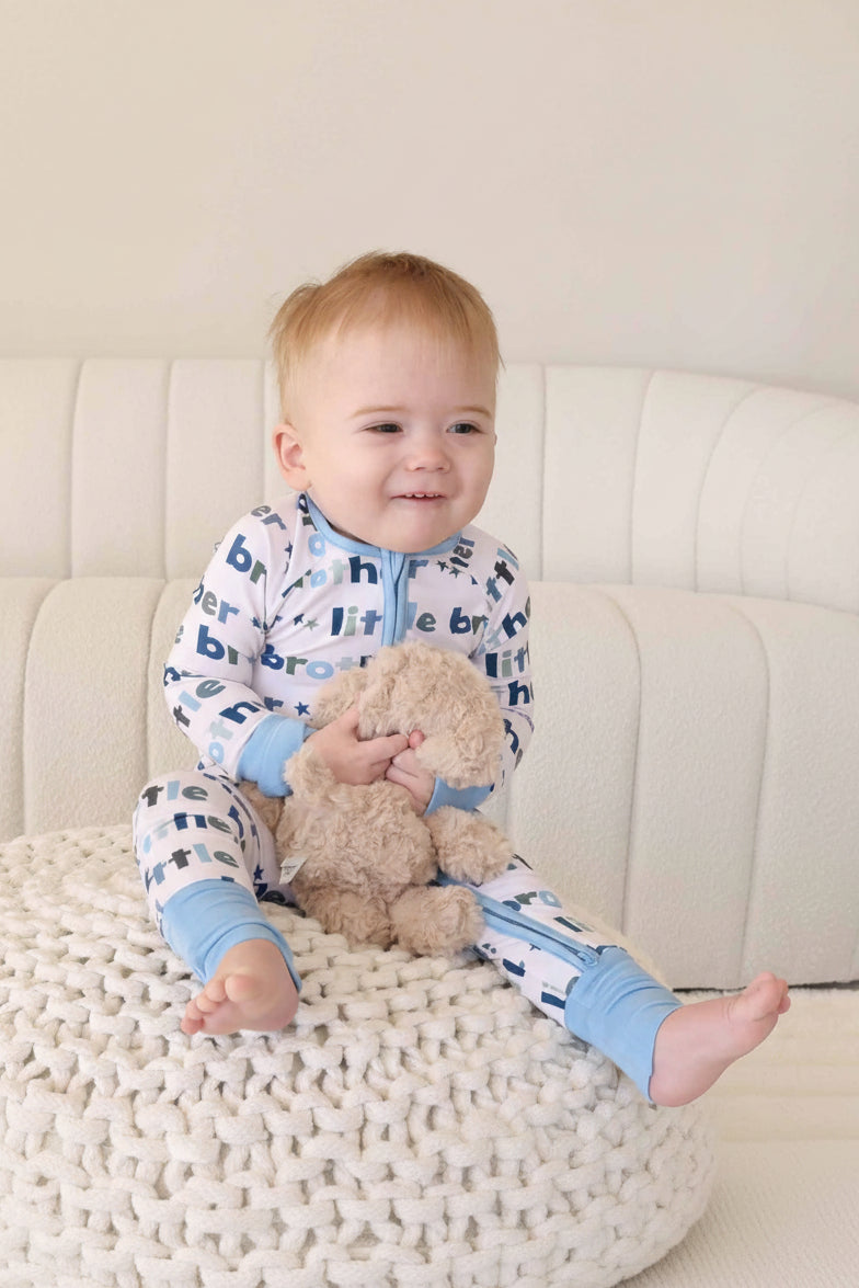 boy wearing little brother zip romper