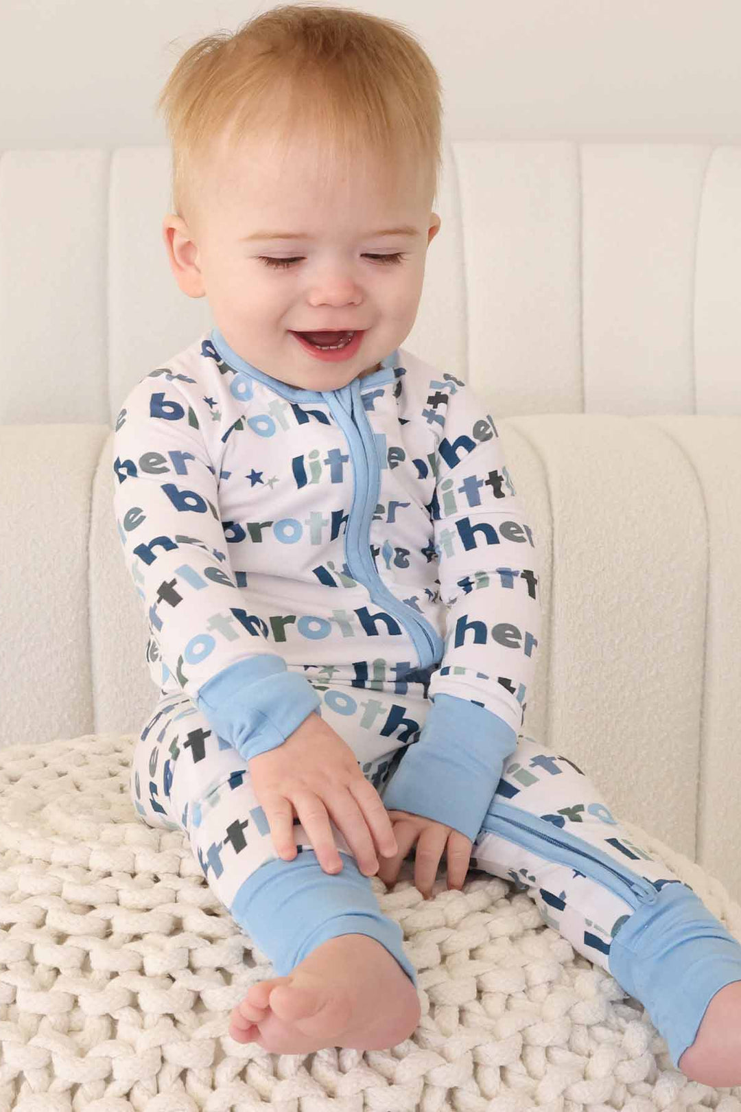 boy wearing little brother zip romper