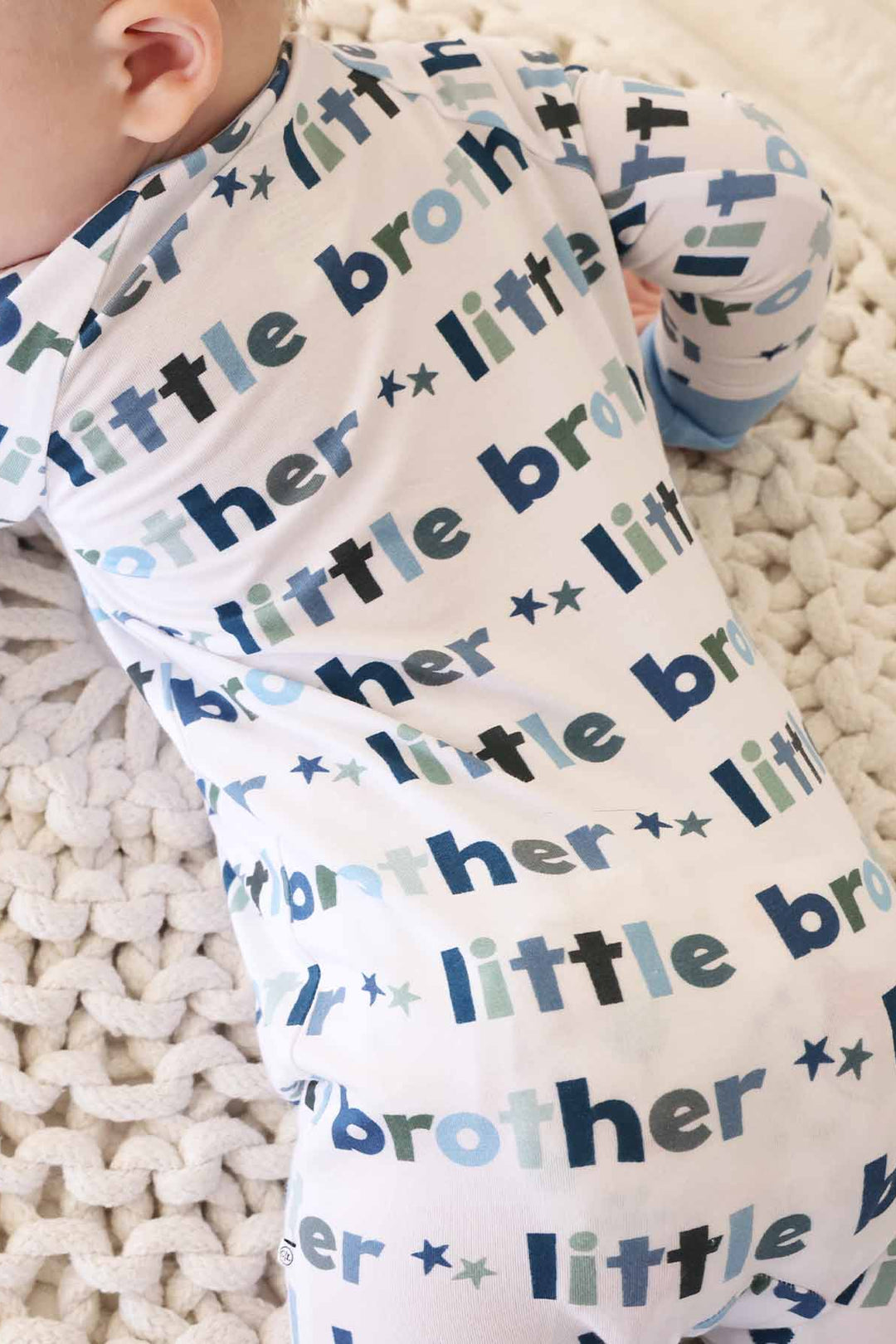 boy wearing little brother zip romper