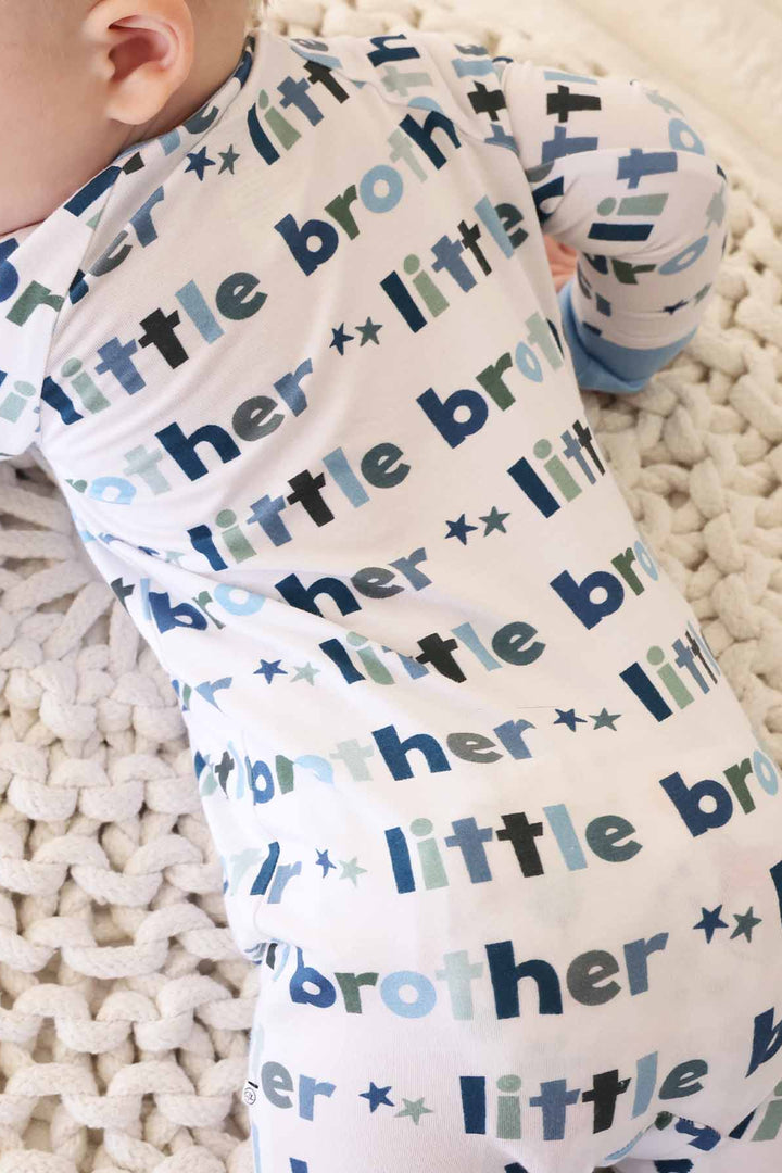 boy wearing little brother zip romper