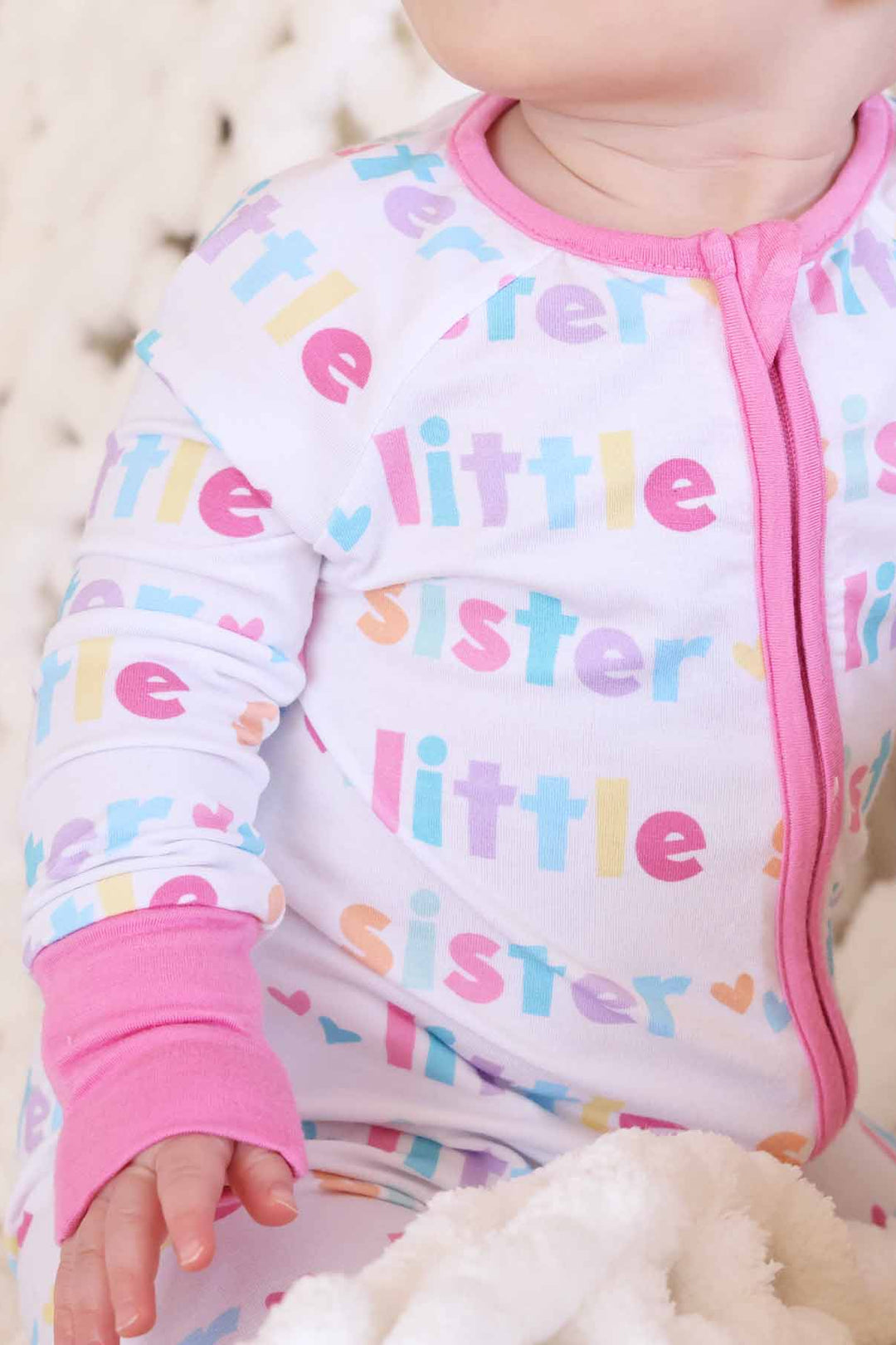 baby girl wearing little sister zip romper