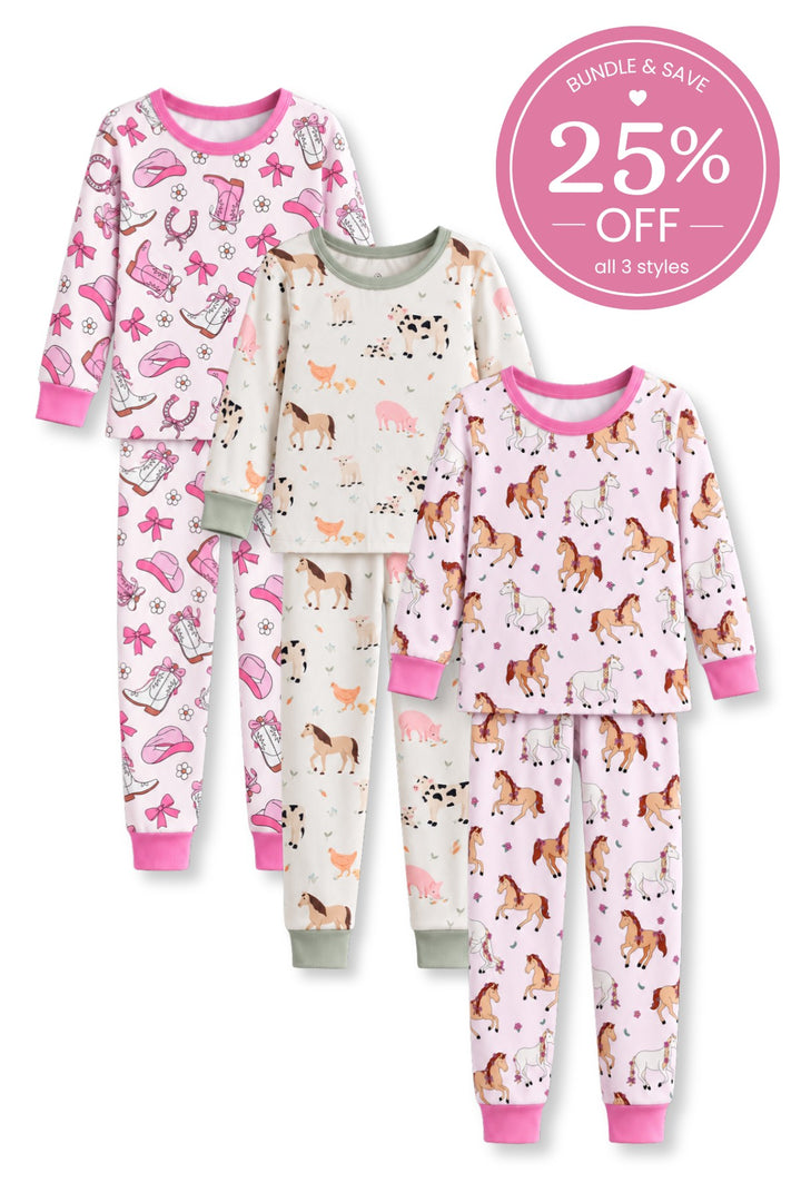 Flat lay of three Caden Lane two-piece pajama sets in pink cowgirl boot, farm animal, and bow-braided pony prints.