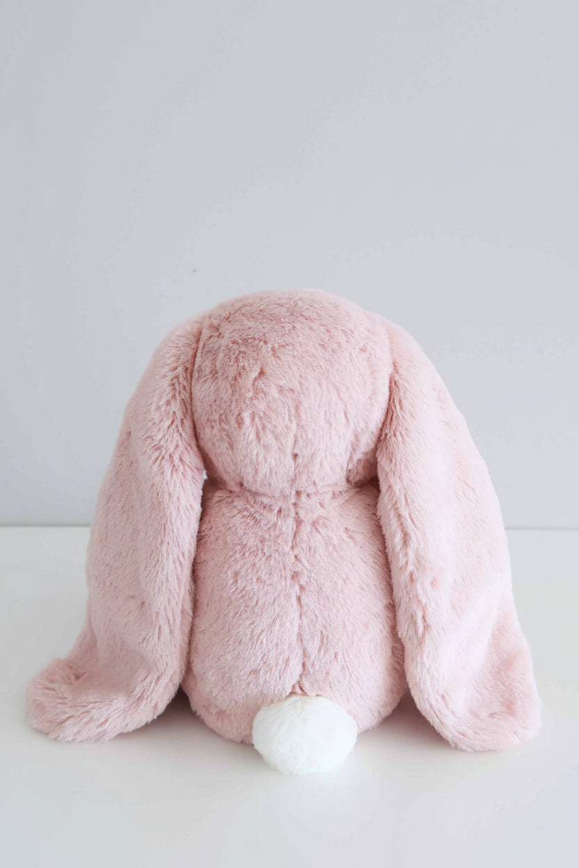back angle picture of pink bunny stuffed animal with a white tail