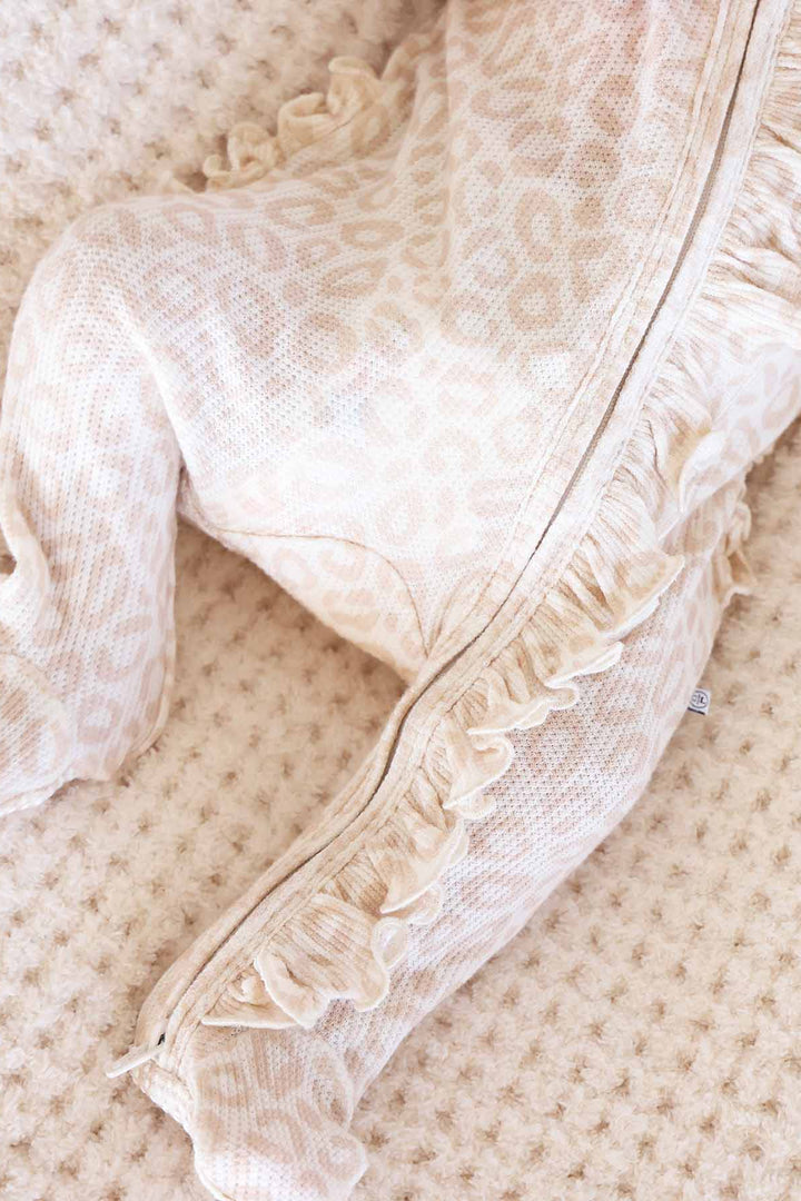 neutral leopard baby footie with ruffles down the zipper 