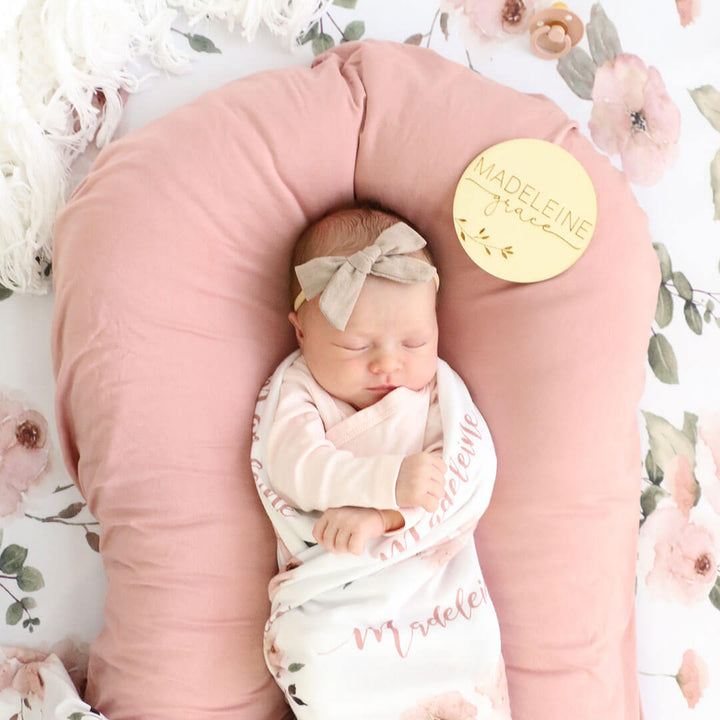wood announcement sign with baby name and branches 