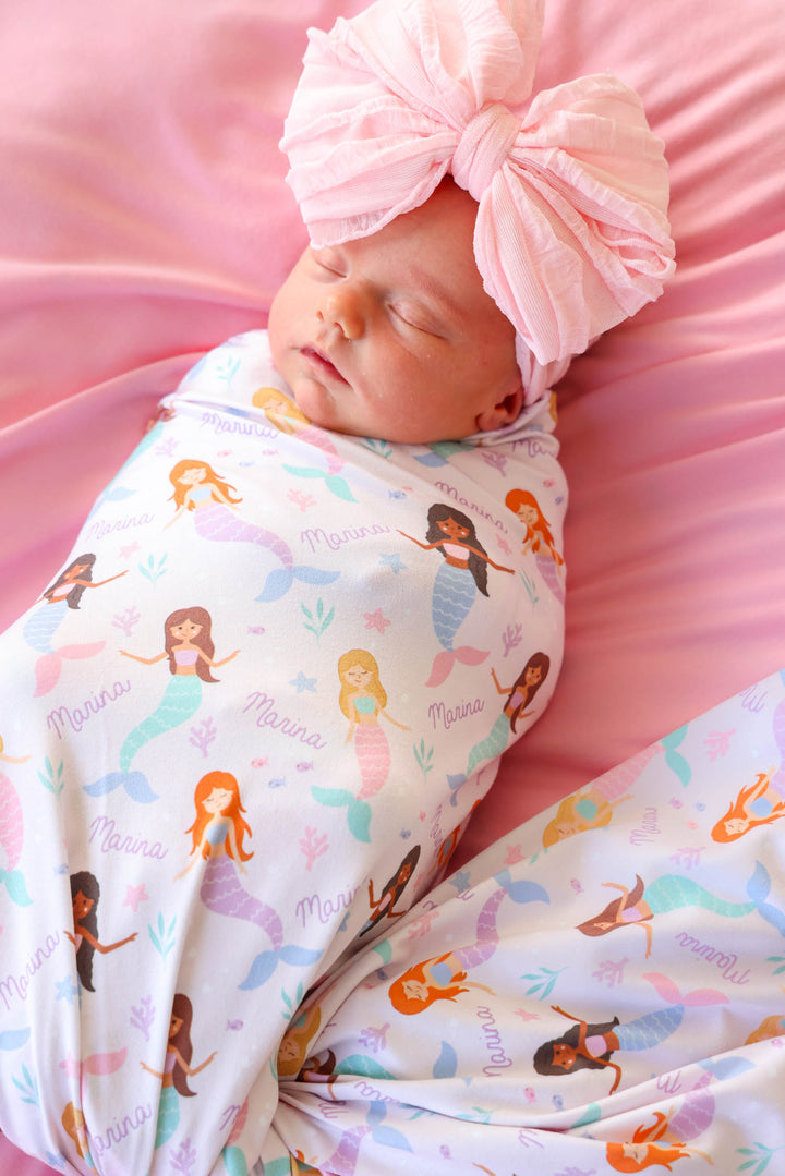 baby wrapped in personalized let's be mermaids swaddle blanket, lifestyle
