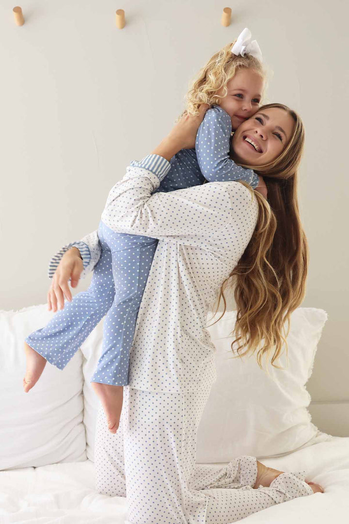 mom and daughter hugging in coordinating polka dot lounge set dusty blue and white polka dots 