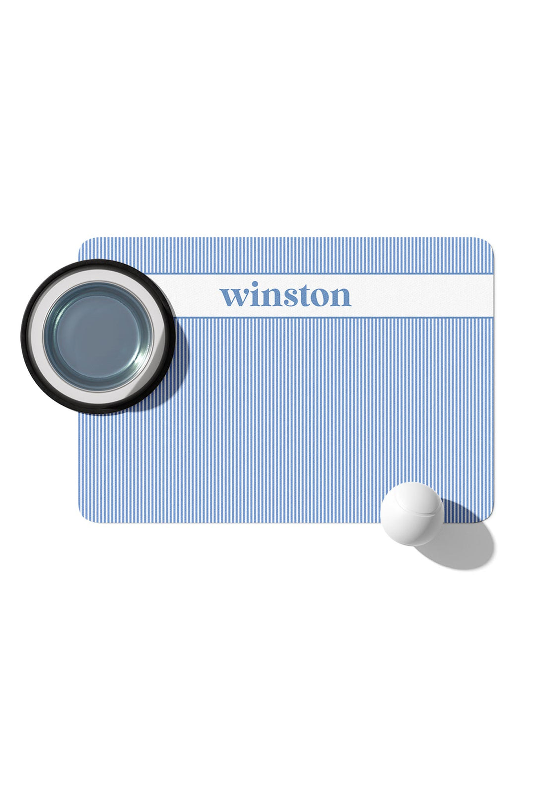 Morning Mist light blue and white striped personalized pet placemat with Winston embroidered in navy, shown with a food bowl and water dish on top