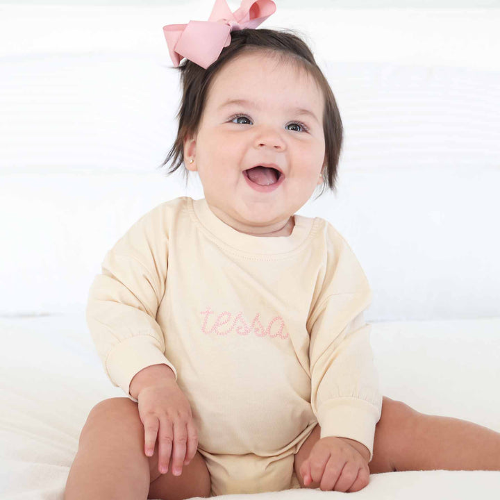 light pink embroidered name romper